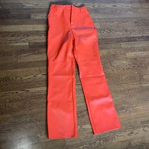 Neon orange leather pants